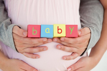 pregnant-lady-holding-baby-building-blocks